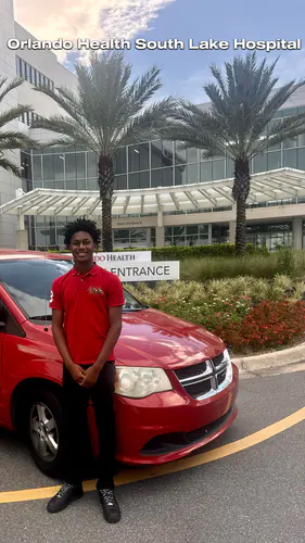 Comfort Ride Transportation driver and van at the Orlando Health South Lake Hospital main entrance in Clermont