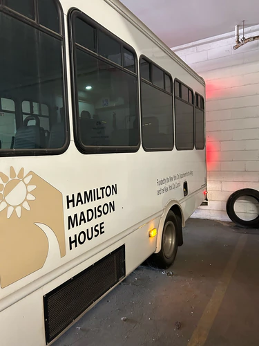 Comfort Ride Transportation shuttle bus parked in a garage during a stop in Alachua