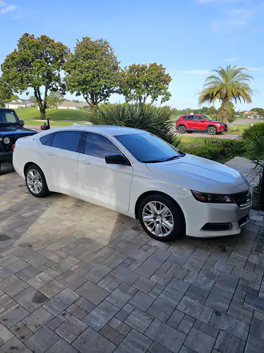 Comfort Ride Transportation white sedan parked outside a home in Citra for a non-emergency medical ride