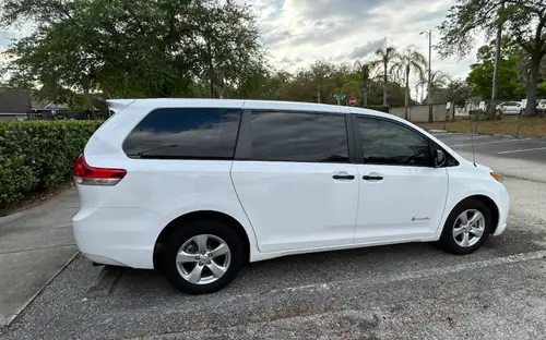White Toyota Sienna minivan parked at a senior center in The Villages for a pickup